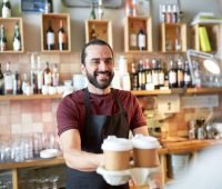 coffee shop owner serving drinks