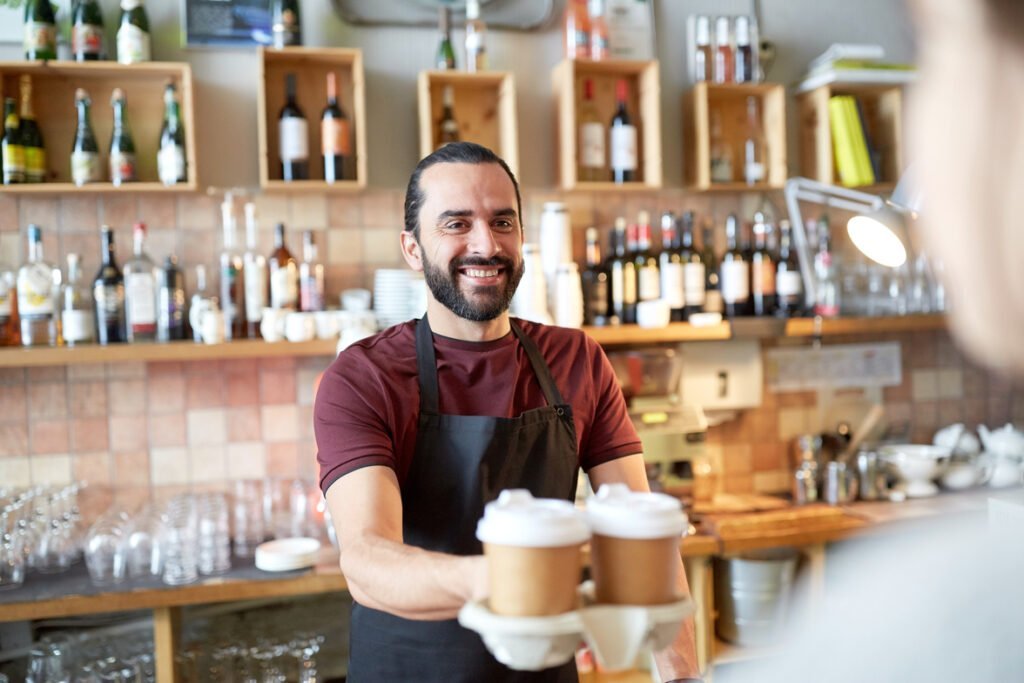 coffee shop owner serving drinks